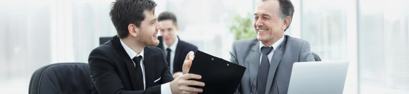 adult-businessman-discussing-financial-documents-with-young-colleague_Edited adult-businessman-discussing-financial-documents-with-young-colleague_Edited